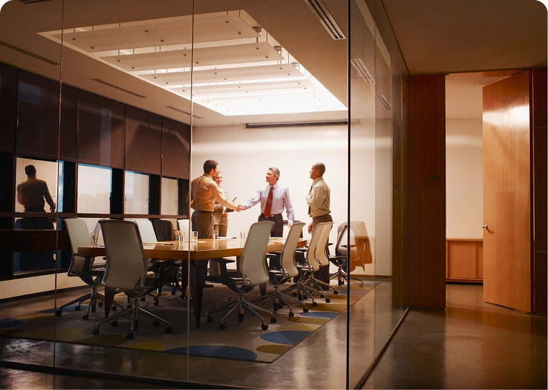 Professionals shaking hands in modern office